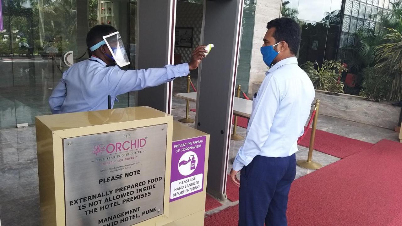 The Orchid Hotel Hinjewadi Pune Eksteriør bilde Temperature check at the entrance of a hotel in India